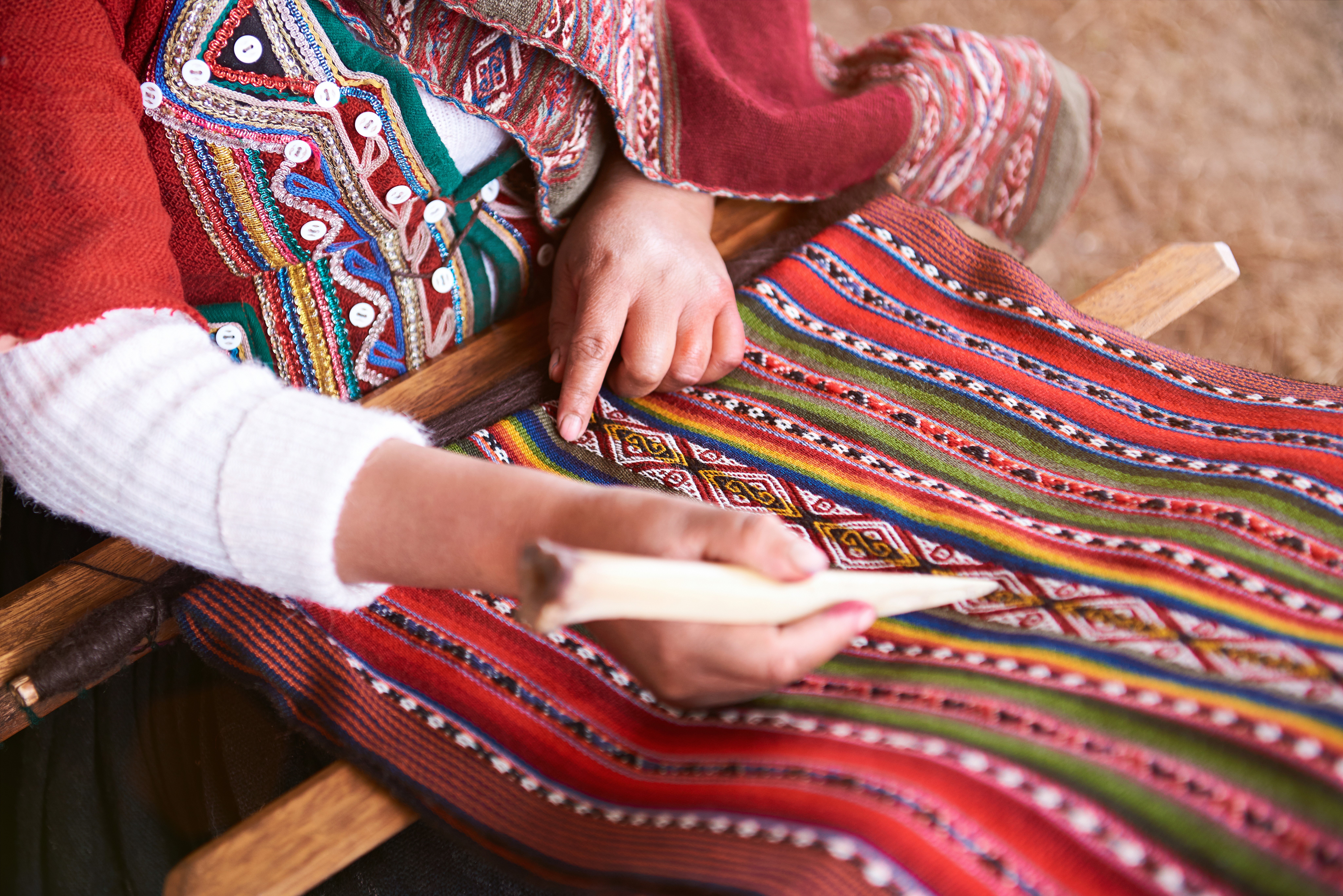 Peruvian artisan creating a textile out of alpaca 